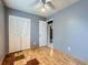Bedroom with wood floors, ceiling fan, and closet at 5481 Xanadu St, Denver, CO 80239