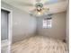 Bedroom featuring neutral walls, laminate wood floors, and a ceiling fan at 5481 Xanadu St, Denver, CO 80239
