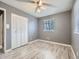 Bedroom with laminate floors, ceiling fan, and window at 5481 Xanadu St, Denver, CO 80239