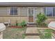 Home's entry features a decorative glass door and a small garden at 5481 Xanadu St, Denver, CO 80239