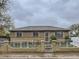 Charming single-story home with a brick and wrought iron fence on a cloudy day at 5481 Xanadu St, Denver, CO 80239