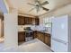 Kitchen with classic cabinetry, neutral tile backsplash, and appliances at 5481 Xanadu St, Denver, CO 80239