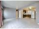 Open-concept living area with kitchen access and tile flooring throughout at 5481 Xanadu St, Denver, CO 80239