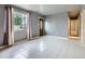 Spacious living room with tile flooring, neutral walls, and natural light at 5481 Xanadu St, Denver, CO 80239