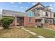 Brick home featuring a classic design, front porch and mature landscaping at 1425 Xavier St, Denver, CO 80204