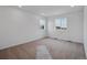 Bright bedroom with carpet, two windows, and fresh white paint at 45909 Wood Thrush Ave, Bennett, CO 80102