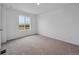 Bright bedroom with carpet, window, and fresh white paint at 45909 Wood Thrush Ave, Bennett, CO 80102