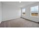 Bright bedroom with neutral carpet and two windows at 45909 Wood Thrush Ave, Bennett, CO 80102