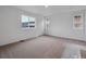 Sunlit bedroom boasts neutral carpet, fresh white paint, and multiple windows at 45909 Wood Thrush Ave, Bennett, CO 80102
