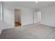 Bright bedroom featuring neutral carpet with bathroom and closet at 45909 Wood Thrush Ave, Bennett, CO 80102