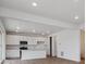 Modern kitchen with white cabinets, stainless steel appliances, and a kitchen island at 45909 Wood Thrush Ave, Bennett, CO 80102