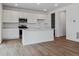 Modern kitchen with stainless steel appliances, white cabinets, and a large island at 45909 Wood Thrush Ave, Bennett, CO 80102