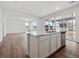 Modern kitchen with large island, stainless dishwasher, sink, and white cabinets at 45909 Wood Thrush Ave, Bennett, CO 80102
