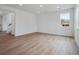 Spacious living room with wood-look floors and recessed lighting throughout at 45909 Wood Thrush Ave, Bennett, CO 80102