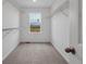 Walk-in closet with wire shelves, and window for natural light at 45909 Wood Thrush Ave, Bennett, CO 80102
