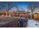 Brick patio with firepit, string lights, and seating area at 5107 Johnson St, Arvada, CO 80002