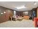 Finished basement Gathering room with sectional sofa and a red mini-fridge at 5107 Johnson St, Arvada, CO 80002