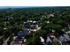 Expansive aerial view capturing a lush, tree-filled neighborhood with diverse rooftops, highlighting the community's serene atmosphere at 3510 Wyandot St, Denver, CO 80211