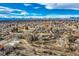 Expansive aerial shot of a quiet residential neighborhood with mountain views on a sunny day at 34 S Raleigh St, Denver, CO 80219