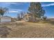 Spacious backyard with a detached two-car garage and mature trees at 34 S Raleigh St, Denver, CO 80219