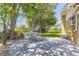 Backyard with a brick house, patio, and mature shade trees, perfect for relaxation at 34 S Raleigh St, Denver, CO 80219