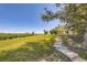 Expansive backyard featuring stone walkway, lamp post, mature trees, and lush landscaping at 34 S Raleigh St, Denver, CO 80219