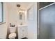 This bathroom features a toilet, sink with vanity, and a shower behind a frosted glass door at 34 S Raleigh St, Denver, CO 80219