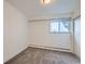 Cozy bedroom features gray carpeting, a window, and white walls, offering a clean and simple design at 34 S Raleigh St, Denver, CO 80219