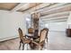 Elegant dining area with chandelier, stone fireplace, wood ceilings, and views of the outdoors at 34 S Raleigh St, Denver, CO 80219