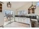 Well-lit kitchen featuring black countertop and backsplash and a view of the backyard at 34 S Raleigh St, Denver, CO 80219