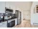 Bright, white kitchen features stainless steel appliances and ample storage space at 34 S Raleigh St, Denver, CO 80219