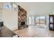Bright living room with an accent stone fireplace and sliding glass door to the backyard at 34 S Raleigh St, Denver, CO 80219