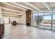 Spacious living room features a stone fireplace, wood ceiling, ample light, and access to the outdoor space at 34 S Raleigh St, Denver, CO 80219