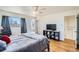 Bright main bedroom features hardwood floors, ceiling fan, and large windows providing lots of natural light at 34 S Raleigh St, Denver, CO 80219