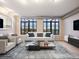Bright living room features large windows, modern decor, and open layout perfect for entertaining at 7110 W Alaska Dr # A, Lakewood, CO 80226