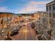 A street view of Belmar showing storefronts, street lights, and trees along the street at 7110 W Alaska Dr # A, Lakewood, CO 80226