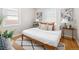 Bright bedroom with hardwood floors, a white comforter, and natural light from windows with wood blinds at 1290 S Elizabeth St, Denver, CO 80210