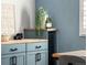 Stylish dining area features custom blue cabinetry with countertop and convenient built-in beverage cooler at 1290 S Elizabeth St, Denver, CO 80210