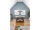 Bright dining area with vaulted ceilings, wood floors, modern chandelier, and large windows with shutters at 1290 S Elizabeth St, Denver, CO 80210
