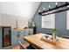 Dining area with a built in bar, modern lighting, and hardwood flooring at 1290 S Elizabeth St, Denver, CO 80210