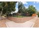Well-maintained property featuring a secure wrought iron fence, mature trees, and professional landscaping at 1290 S Elizabeth St, Denver, CO 80210