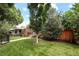 Charming home with lush greenery, manicured lawn, and mature trees for a serene setting at 1290 S Elizabeth St, Denver, CO 80210