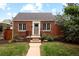 Quaint brick house with a well-manicured lawn and garden beds, offering a cozy and welcoming atmosphere at 1290 S Elizabeth St, Denver, CO 80210
