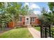 Charming brick home with a well-maintained lawn, mature trees, and inviting curb appeal at 1290 S Elizabeth St, Denver, CO 80210
