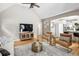 Cozy living room featuring hardwood floors, vaulted ceilings, stylish seating, and a view to the kitchen at 1290 S Elizabeth St, Denver, CO 80210