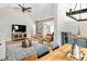 Open living room with vaulted ceiling, hardwood floors, stylish seating, and dining area with custom cabinetry at 1290 S Elizabeth St, Denver, CO 80210