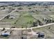 Wide aerial view shows neighborhood, sprawling land, other homes, and roads with a vehicle at 2166 Appaloosa Trl, Elizabeth, CO 80107