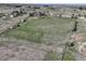 Drone shot of a wide expanse of property, showcasing its expansive land and distant neighboring houses at 2166 Appaloosa Trl, Elizabeth, CO 80107