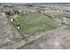 Aerial view captures the property's open space and distant homes against a clear sky at 2166 Appaloosa Trl, Elizabeth, CO 80107