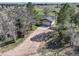 Aerial view captures this home's location, featuring a driveway, lawn, mature trees, and neighborhood views at 2166 Appaloosa Trl, Elizabeth, CO 80107
